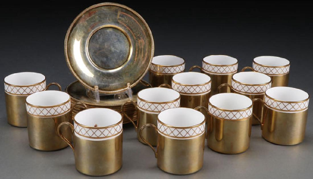 TIFFANY STERLING & SPODE DEMITASSE SET: A TIFFANY AND CO. STERLING-GILT AND SPODE PORCELAIN DEMITASSE SET, FIRST HALF 20TH CENTURY. Service for 12 each comprising a white glazed Spode porcelain insert with gilt lattice decorated rim set in 