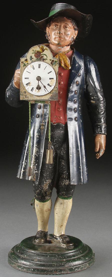 19TH CENTURY TOLE PAINTED FIGURAL CLOCK: A CONTINENTAL 19TH CENTURY TOLE PAINTED TIN FIGURAL CLOCK. Depicting the figure of a clock maker with clock strapped to back and chest. The latter containing a functional key wind watch movement in po