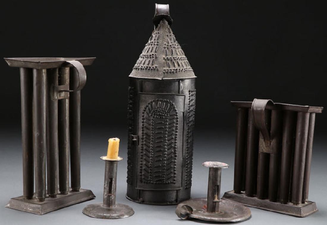 5 EARLY AMERICAN LIGHTING DEVICES: A GROUP OF FIVE AMERICAN METAL CANDLESTICK AND LIGHTING DEVICES, 19TH CENTURY. Comprising a pierced and punched sheet-iron/tin candle lantern, cylindrical form with strap handle, hinged door and a sin