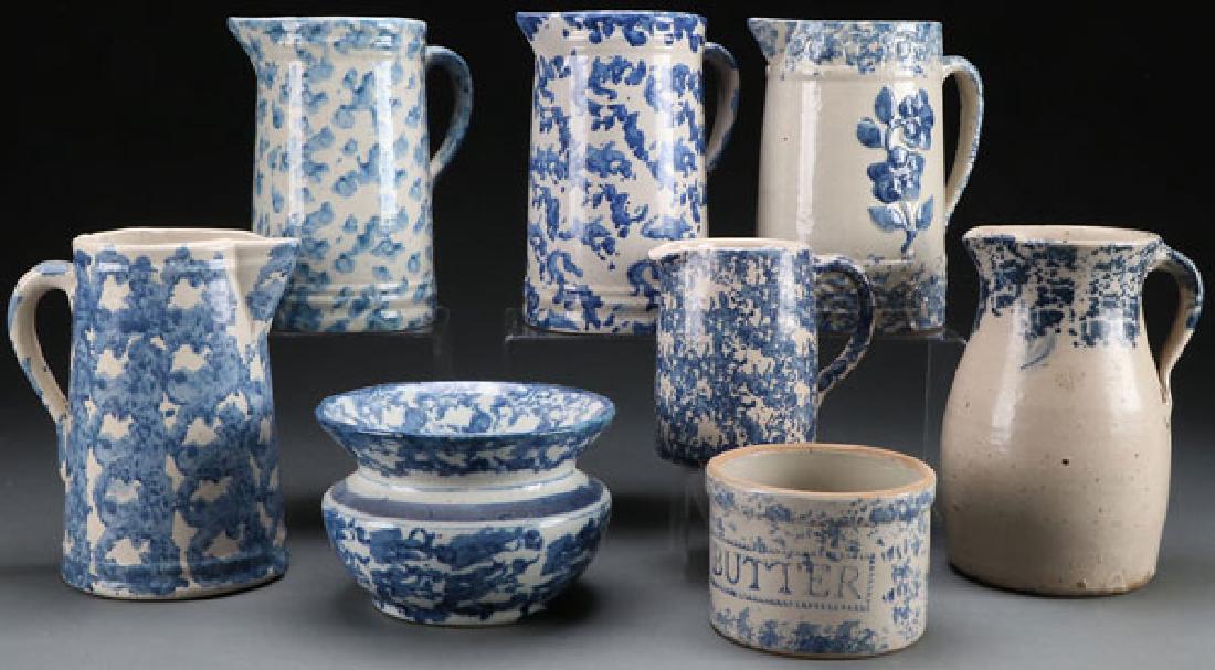 8 PIECE SPONGE DECORATED STONEWARE: AN EIGHT PIECE GROUP OF SPONGE DECORATED STONEWARE, LATE 19TH/EARLY 20TH CENTURY. Comprising 6 pitchers; one with embossed wild rose, a butter tub, and a spittoon. The largest 9 inches (22.8 cm). SHIP