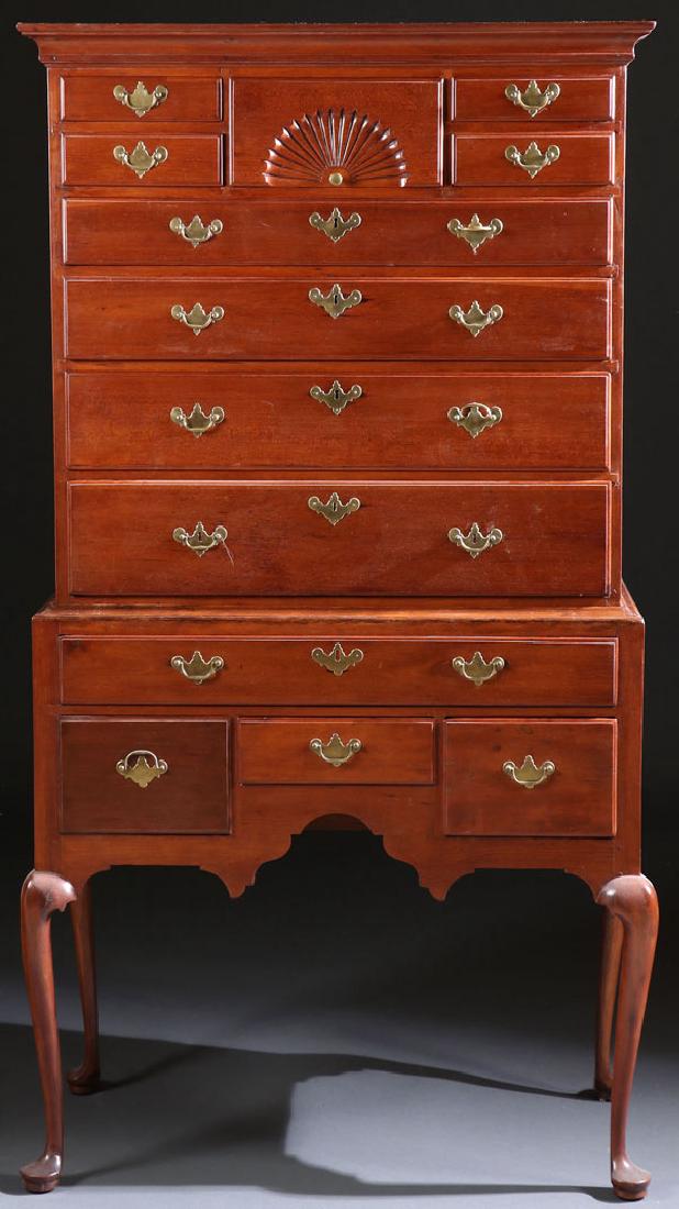 A VERY FINE EARLY AMERICAN QUEEN ANNE HIGHBOY: A VERY FINE EARLY AMERICAN QUEEN ANNE HIGHBOY, CIRCA 1760. Probably Connecticut cherry wood. The nine drawer top with upper central fan carved design raised on a four drawer base with cabriole legs te