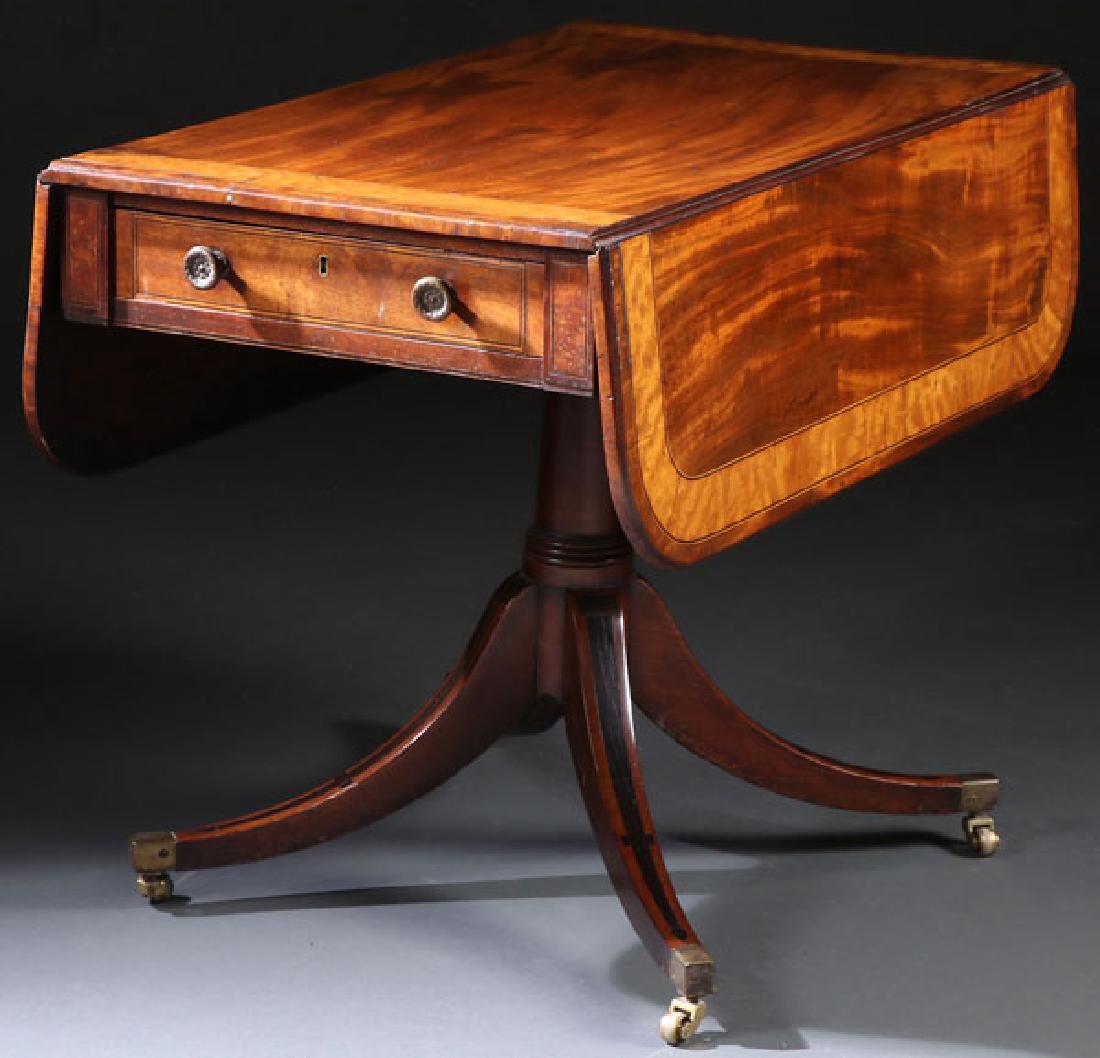 A GOOD GEORGIAN BREAKFAST TABLE, EARLY 19TH C: A GOOD GEORGIAN BREAKFAST TABLE, EARLY 19TH CENTURY. Mahogany with drop leaf top and satin wood inlaid bands raised on a turned pedestal supported by four ebony inlaid sabre form legs with bronze cas