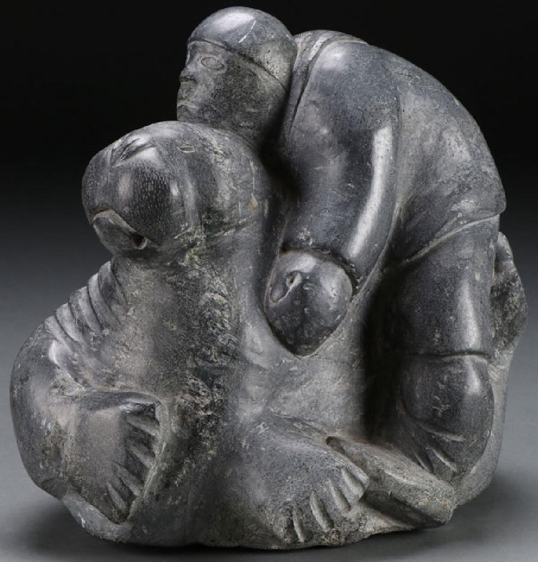 SOAPSTONE CARVED INUIT FIGURE WITH WALRUS: A SOAPSTONE CARVED INUIT FIGURE WITH TUSKED WALRUS. Height 8 inches (20.3 cm). SHIPPING NOTICE: Jackson’s is your sole and only source for one stop packing and shipping. With over 50 years of experi