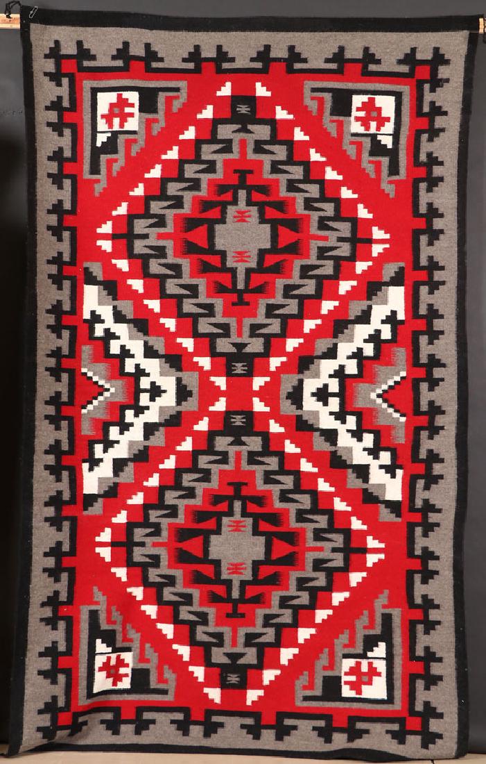 A SOUTHWEST NAVAJO “GANADO” HANWOVEN RUG: A LARGE AND VERY FINE SOUTHWEST NAVAJO “GANADO” HANDWOVEN WOOL RUG, CIRCA 1976. With Crownpoint weaver’s rug label for Marie Tom, Crown Point, New Mexico. 92 inches x 56 inches. SHIPPING NOTICE