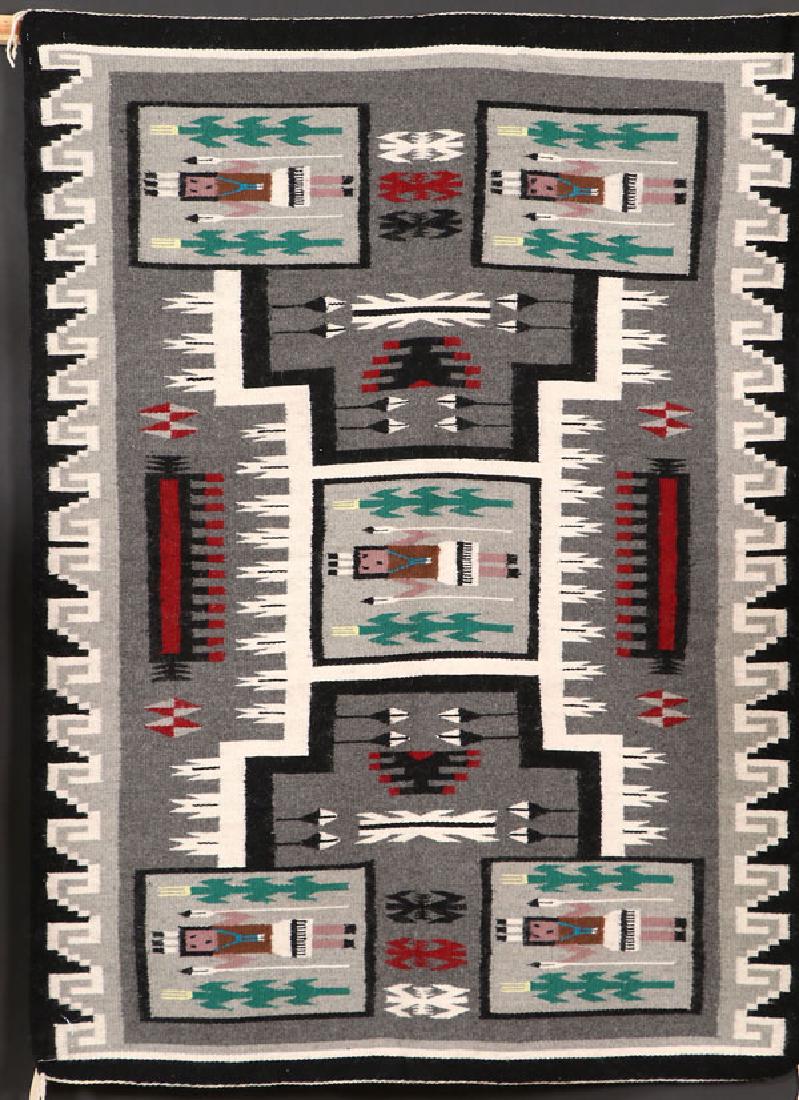 A SOUTHWEST NAVAJO “YEI STORM PATTERN” RUG: A SOUTHWEST NAVAJO “YEI STORM PATTERN” HANDWOVEN WOOL RUG, 3RD QUARTER OF THE 20TH CENTURY. With Crownpoint weaver’s rug label for Sadie Jim. 64 inches X 47 inches. SHIPPING NOTICE: Jackson’s 