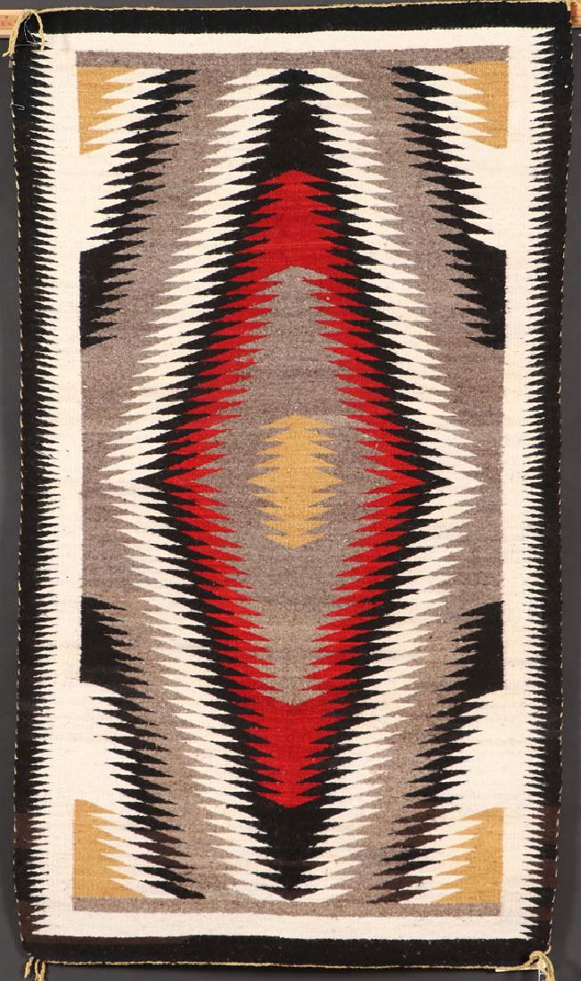 TWO SOUTHWEST NAVAJO HANDWOVEN WOOL RUGS: TWO SOUTHWEST NAVAJO HANDWOVEN WOOL RUGS, 3RD QUARTER OF THE 20TH CENTURY. Each with Crownpoint rug weaver’s labels comprising an Eleanor Nez, Pinon AZ, 51 inches x 35 inches and a Nancy Etsitty, Ch