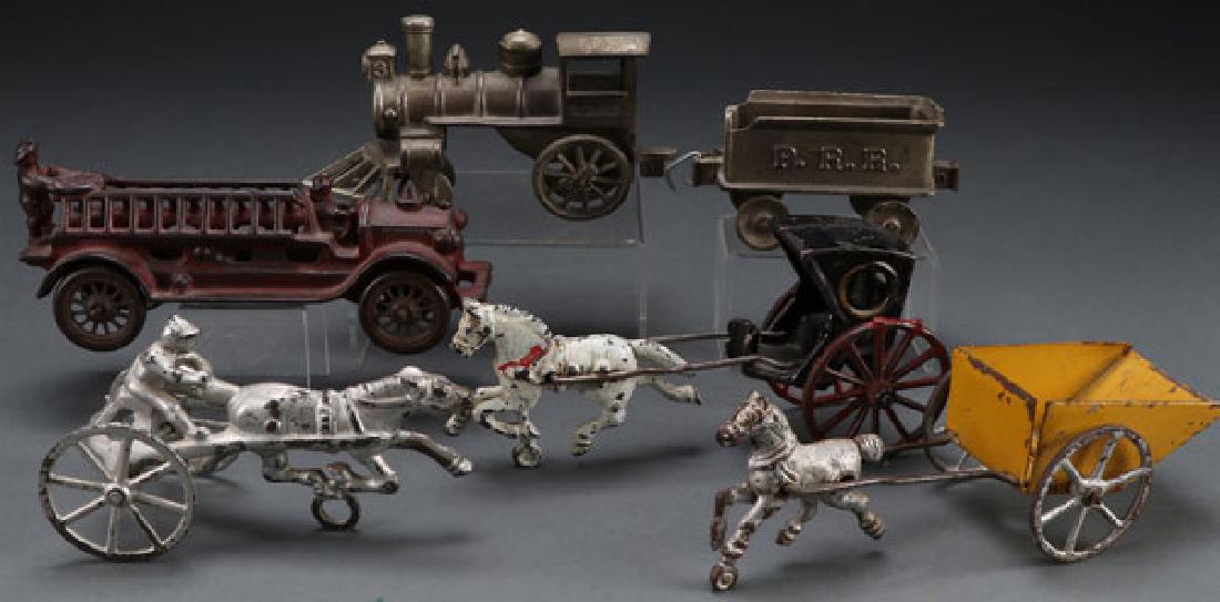 FIVE VINTAGE CAST IRON TOYS, EARLY 20TH CENTURY: FIVE VINTAGE CAST IRON TOYS, EARLY 20TH CENTURY. Comprising a 7.5 inch ladder truck, a 11.5 inch nickel plate locomotive and tender embossed P. R. R., a horse and sulky, a horse and buggy, and a horse