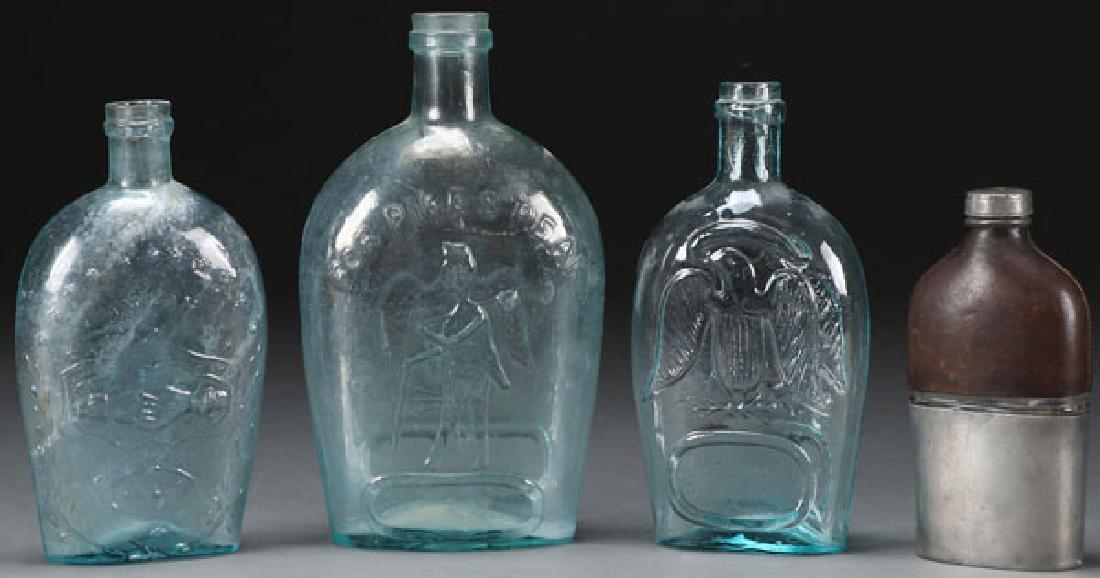 FOUR CIVIL WAR GLASS FLASKS: FOUR CIVIL WAR GLASS FLASKS. Two with the Union Eagle, the largest example with veteran in silhouette for Pike’s Peak, and the third with cannon and flag and on verso the word Union above two claspe