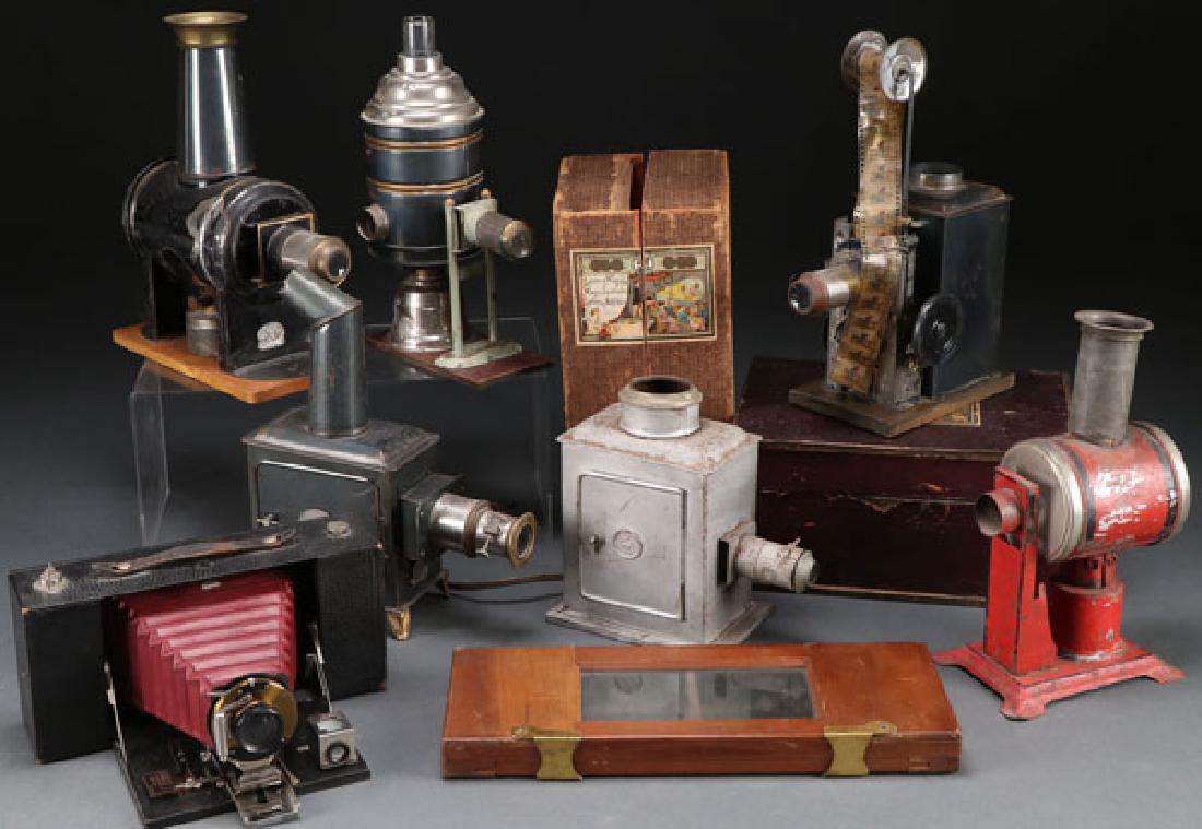 A GROUP OF SIX VINTAGE MAGIC LANTERNS: A GROUP OF SIX VINTAGE MAGIC LANTERNS. Of various types, mostly oil lit together with an early roll film projector. One in original box. The largest 12 inches. SHIPPING NOTICE:Jackson’s is your sol