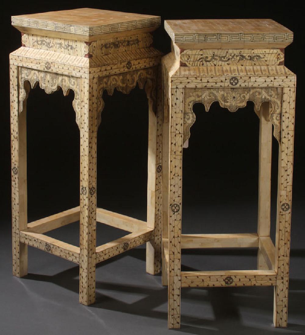 A PAIR OF MATCHING CHINESE CARVED BONE PEDESTALS: A PAIR OF MATCHING CHINESE CARVED BONE PEDESTALS, 20TH CENTURY. In the Ming taste, of squared form raised on four legs incised with dragons, rosettes and geometric designs. Height 39.75 inches (101 cm