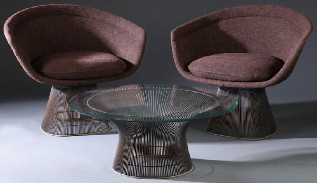 3 PIECE WARREN PLANTAR FOR KNOLL LOUNGE SUITE: A THREE PIECE WARREN PLANTAR FOR KNOLL LOUNGE SUITE, CIRCA 1970. Comprising two upholstered arm chairs on wire cage pedestals and a round cocktail table with glass top. Each with original upholstery a