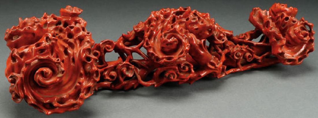 A CARVED WOOD AND RED LACQUERED RUYI SCEPTER: A CHINESE CARVED WOOD AND RED LACQUERED RUYI SCEPTER. In the form of scrolling vines with reticulated stems and fungus heads. Height 18.75 inches (47.5 cm). SHIPPING NOTICE: Jackson's is you