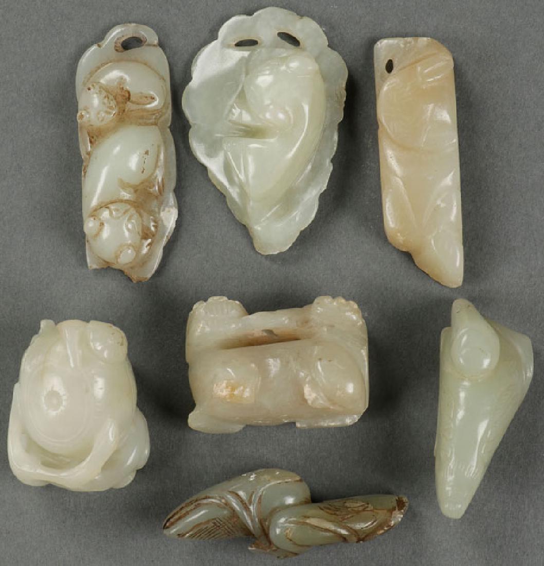 A GROUP OF SEVEN CARVED WHITE JADE ORNAMENTS (1 of 1)
