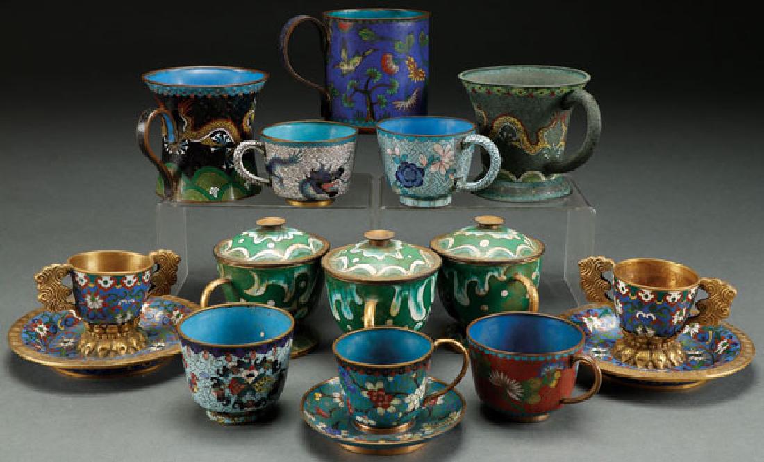 A 13 PIECE GROUP OF VINTAGE CHINESE ENAMELED: A 13 PIECE GROUP OF VINTAGE CHINESE ENAMELED CLOISONNÉ CUPS. Comprising three early gilt bronze cups enameled with fish, a pair of gilt cups with lotus base saucers, two handled mugs with dragons, a 