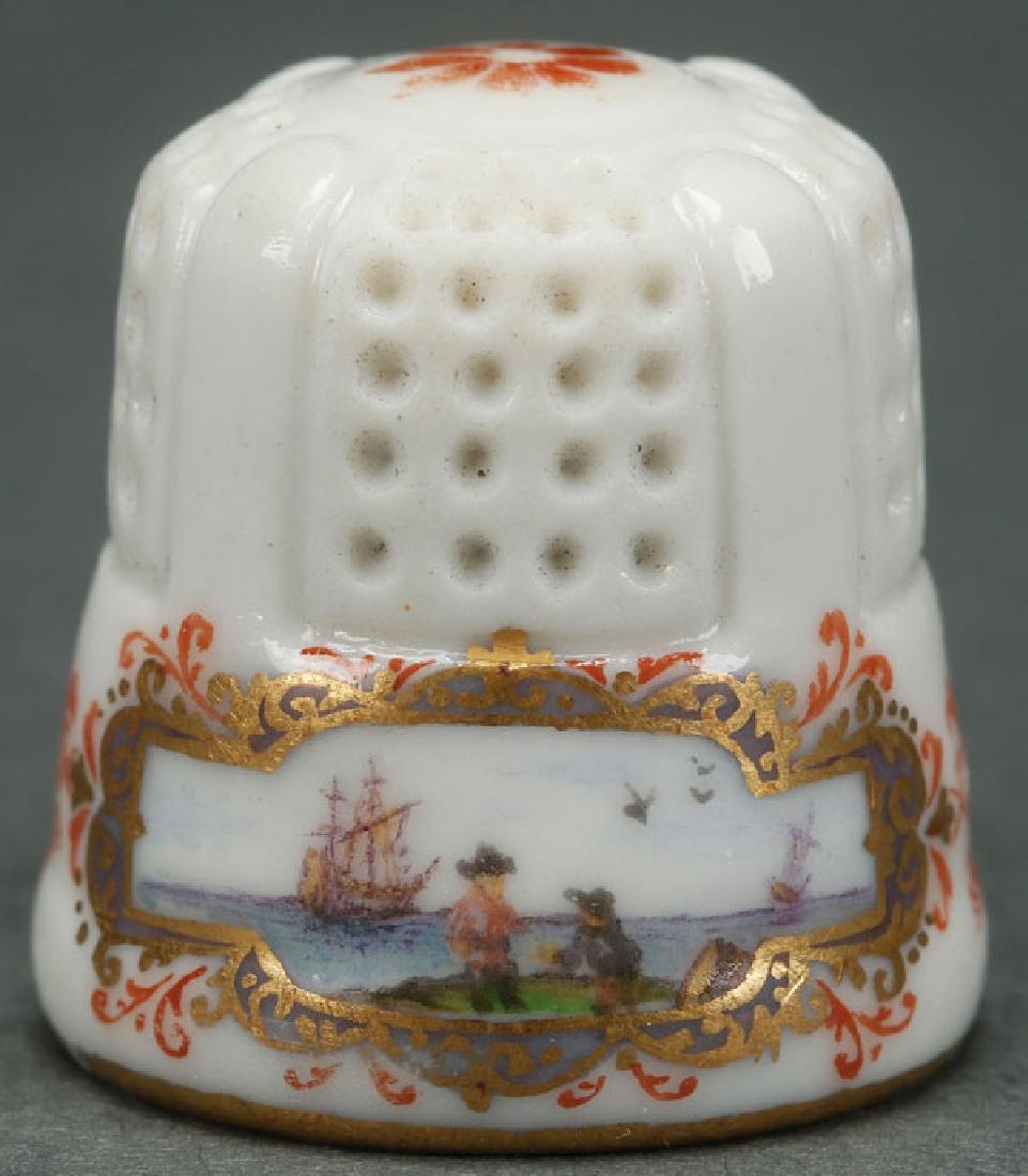 A VERY FINE MEISSEN THIMBLE, LAST HALF 18TH C: A VERY FINE MEISSEN THIMBLE, LAST HALF 18TH CENTURY. The lower rim decorated with three navel scenes within gilt cartouches. The top center with a red oxide rosette. The interior finished in gilt, app