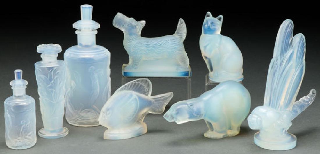AN EIGHT PIECE GROUP OF SABINO FRENCH ART GLASS: AN EIGHT PIECE GROUP OF SABINO FRENCH ART GLASS. All in opalescent molded glass comprising a large and small dresser bottle with nude women bathers and swan, a dresser bottle with iris and five figure