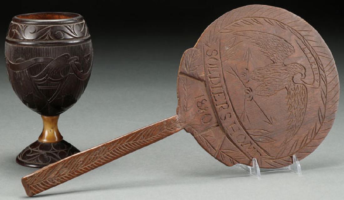 A TWO PIECE GROUP OF EARLY AMERICANA "EAGLES": A TWO PIECE GROUP OF EARLY AMERICANA "EAGLES" CARVED WOODEN WARES, 19th CENTURY. Comprising a carved coconut chalice with American eagle horse and horseshoe motif joined to base with a bone stem and