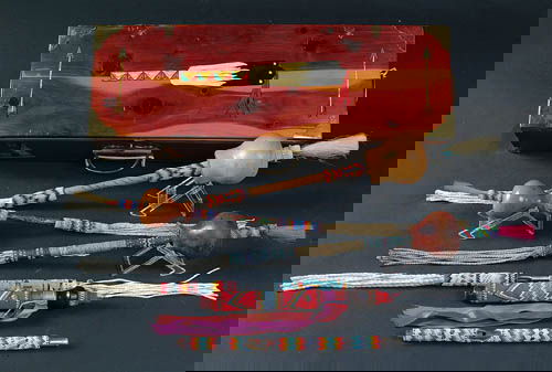 A KIOWA CEDAR PEYOTE PAINTED BOX with 3 finely be: A KIOWA CEDAR PEYOTE PAINTED BOX with 3 finely beaded Peyote rattles, beaded fan handles, dance wand and flute. Box signed "Betty Chetopah". 20th century. 4.25"x7"x21". Estimate $400-$600