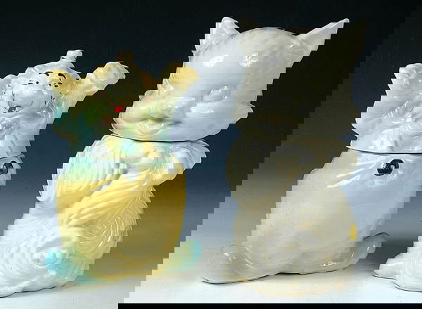 A PAIR OF AMERICAN BISQUE COOKIE JARS, a "Happy C: A PAIR OF AMERICAN BISQUE COOKIE JARS, a "Happy Clown", height 11", some paint loss, and "Fluffy the Cat", height 13", unpainted. Estimate $150-$250