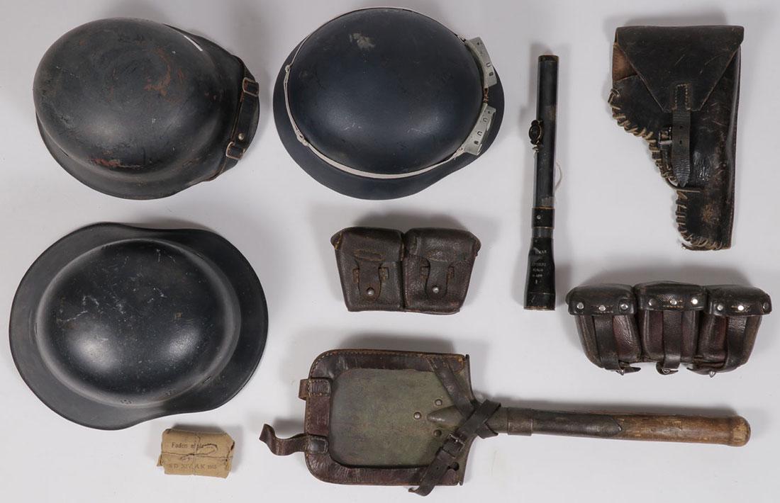 EIGHT GERMAN WWII ITEMS: EIGHT GERMAN WWII ITEMS. Comprising a gladiator style Luftschutz helmet, a police helmet with side vents, another helmet, a pair of leather pebble finish belt cartridge boxes, entrenching tool, a sigh