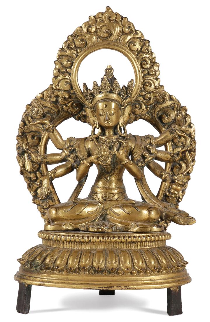 A FINE GILT BRONZE FIGURE OF A BUDDHIST DEITY: A FINE GILT BRONZE FIGURE OF A BUDDHIST DEITY & MANDORLA PROBABLY 17TH/18TH CENTURY. The finely sculpted and cast multi-headed deity wearing Buddhist tiaras surrounding the stupa-form headdress finial