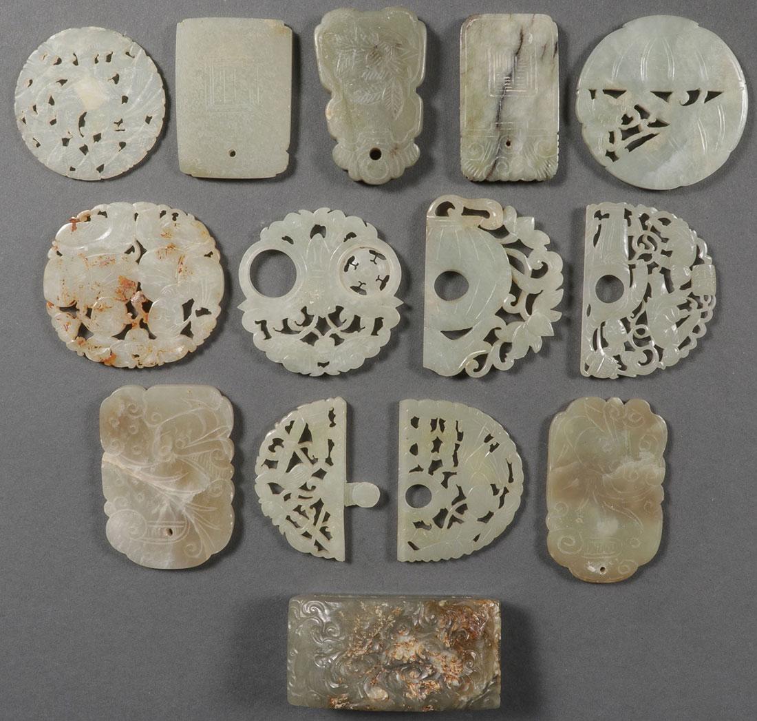 13 CHINESE CARVED JADE PENDANTS AND ORNAMENTS: A GROUP OF THIRTEEN CHINESE CARVED JADE PENDANTS AND ORNAMENTS, PRIMARILY QING DYNASTY. Including five traditional pendant forms, a good heavy belt loop, as well as partial pierced belt buckles, thre