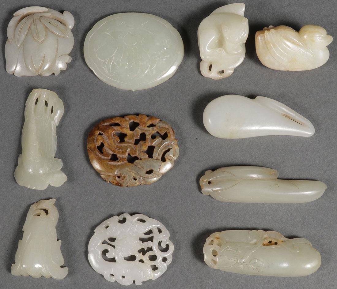 10 CHINESE CARVED JADE PENDANTS, QING DYNASTY: A GROUP OF TEN CHINESE CARVED JADE FIGURAL PENDANTS, QING DYNASTY. Depicting various forms including vegetation, a bird, reclining cat, and a very finely carved open work white jade dragon pendant, to