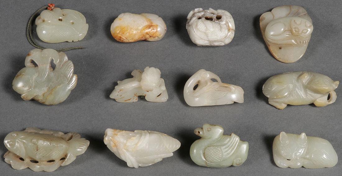 A GROUP OF TWELVE CHINESE CARVED JADE PENDANTS: A GROUP OF TWELVE CHINESE CARVED JADE PENDANTS, MOSTLY QING DYNASTY. Depicting various life forms, fish, birds, cats, Foo Dog, and cicada. Greatest length 2 inches (5 cm).SHIPPING NOTICE: