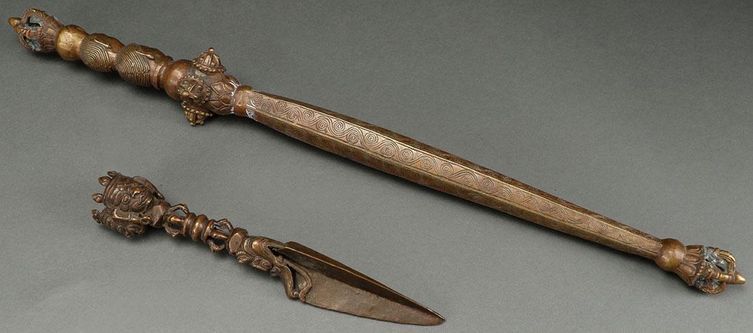 A PAIR OF BRONZE RITUAL IMPLEMENTS: A PAIR OF BRONZE RITUAL IMPLEMENTS. Comprising a Chinese bronze ritual scepter and a bronze Tibetan vajrakila. The longest 20 inches (51 cm). SHIPPING NOTICE: Jackson's is your sole and o