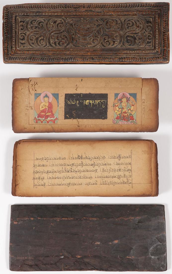 A TIBETAN/HIMALAYAN SUTRA WITH COVERS: A TIBETAN/HIMALAYAN SUTRA WITH COVERS, 19TH CENTURY. The top cover carved with scrolling foliage and containing 160 black pages inscribed with text on both sides, one page illuminated with Buddhist de