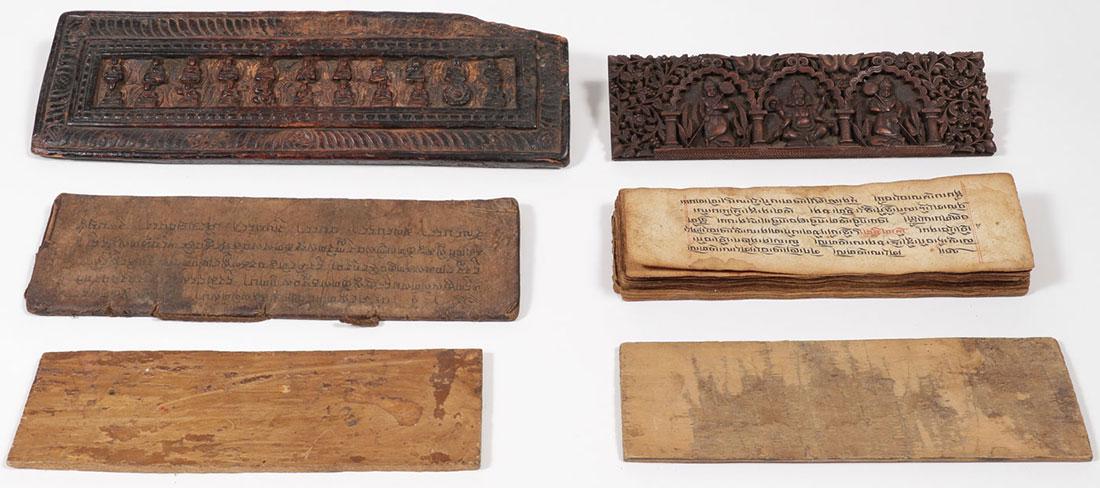 TIBETAN OR HIMALAYAN CARVED SUTRA COVERS & TEXT: A PAIR OF TIBETAN/HIMALAYAN SUTRAS WITH COVERS, 18TH/19TH CENTURY. The largest carved cover with various Buddhist deities containing 18 pages inscribed with text on both sides, 13.75 inches (35 cm), t