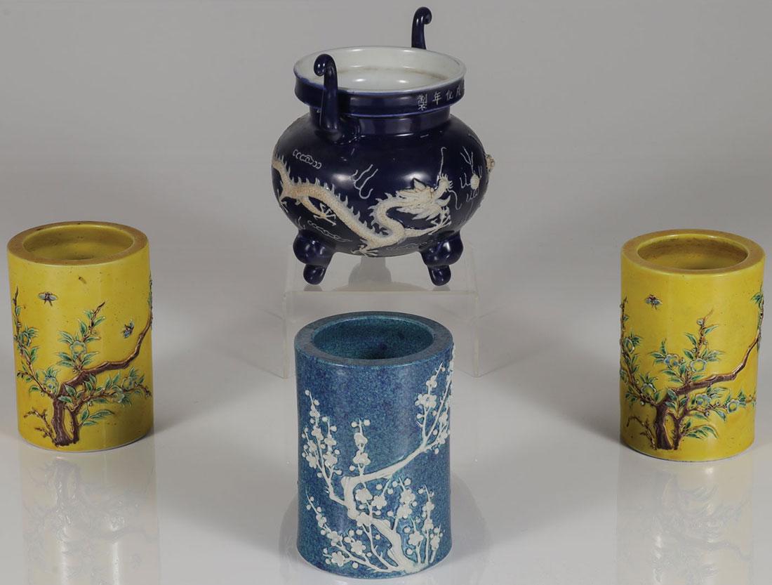 FOUR CHINESE CERAMIC VESSELS: FOUR CHINESE CERAMIC VESSELS. Including a footed incense form vessel with raised dragon decoration and Chinese characters on the rim. Together with three similar cylindrical vessels, two matching. Gre