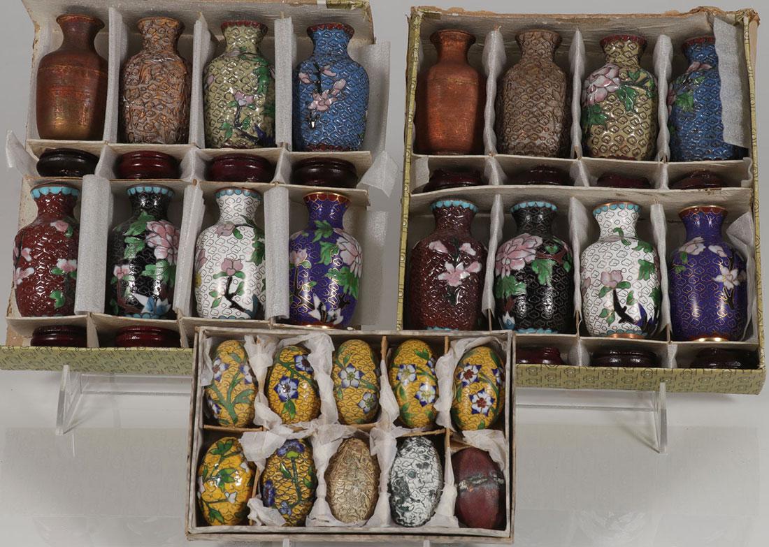 THREE CHINESE CLOISONNÉ PRODUCTION SETS: THREE CHINESE CLOISONNÉ PRODUCTION SETS. Comprising two cased sets of eight vases and a set of ten eggs each displaying the various stages of cloisonné production. Greatest measurement 3.25 inches (