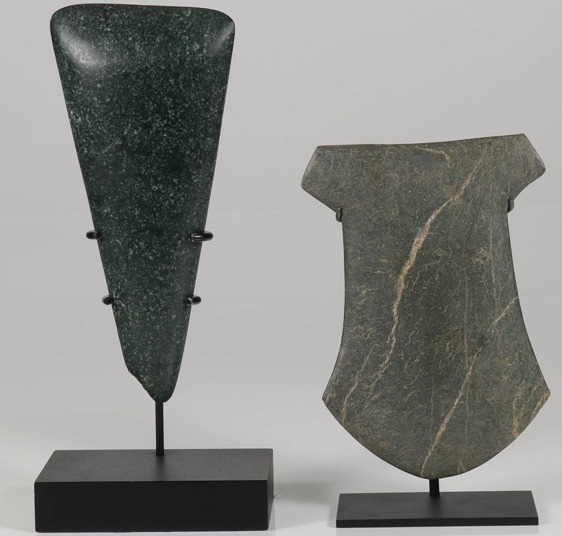 PRE-COLOMBIAN CEREMONIAL POLISHED AX & CELT: A CEREMONIAL POLISHED AX AND CELT, COLIMA AND VALDIVIA. Each finely shaped and polished and resting in custom display stands. The largest being the Celt, 12.5 inches (32 cm) and the ax 10.5 inches (26