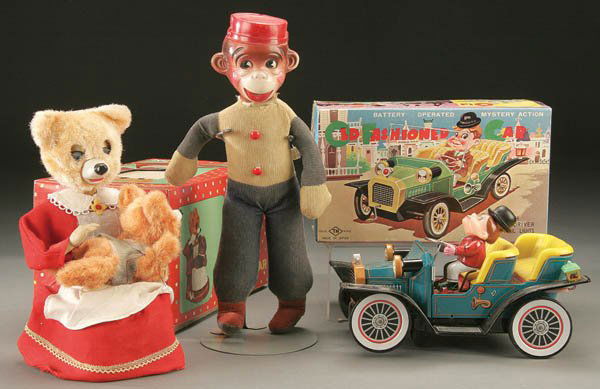 A BATTERY OPERATED SPANKING BEAR TOY AND A MYSTER: A BATTERY OPERATED SPANKING BEAR TOY AND A MYSTERY ACTION JALOPY partial original boxes together with a monkey doll. Estimate $50-$100