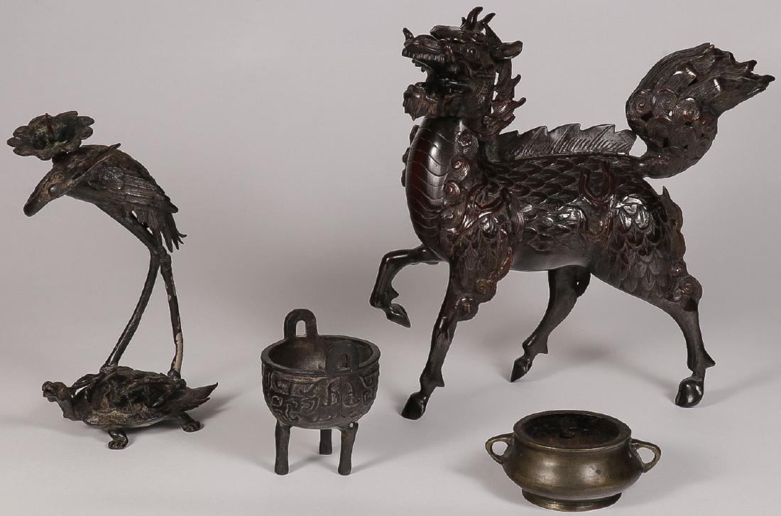 A GROUP OF CHINESE BRONZE, PROBABLY 19TH CENTURY: A GROUP OF CHINESE BRONZE, PROBABLY 19TH CENTURY. Comprising a candlestick modeled as a crane atop a turtle (repaired), a large Foo dog, and two incense burners, the smallest with raised six-character