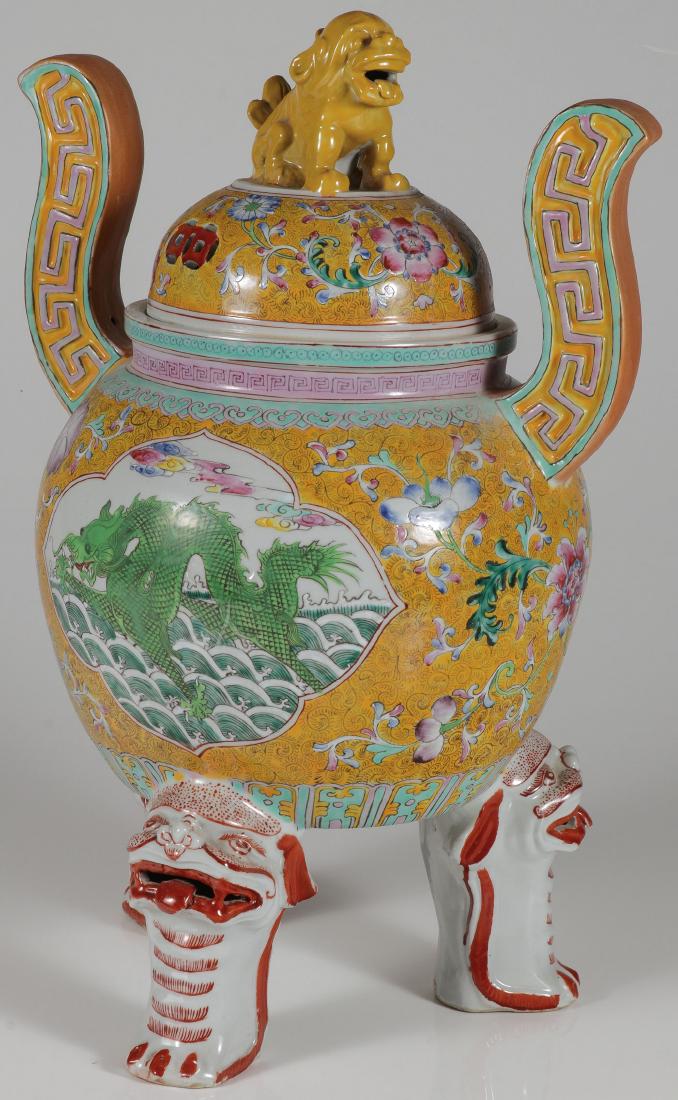A CHINESE FAMILLE ROSE DECORATED PORCELAIN CENSER: A LARGE AND IMPRESSIVE CHINESE FAMILLE ROSE DECORATED PORCELAIN CENSER. Of large proportions resting on three Foo lion paw feet, the sides decorated with dragons, and the fitted lid with Foo lion fini