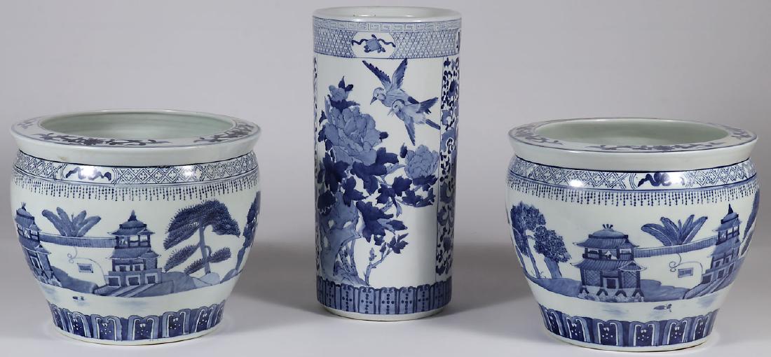 THREE CHINESE BLUE AND WHITE JARDINIERES: THREE CHINESE BLUE AND WHITE JARDINIERES. Comprising a pair of matching examples of traditional form together with a cylindrical jardiniere or umbrella stand. Greatest height 18 inches (46 cm).