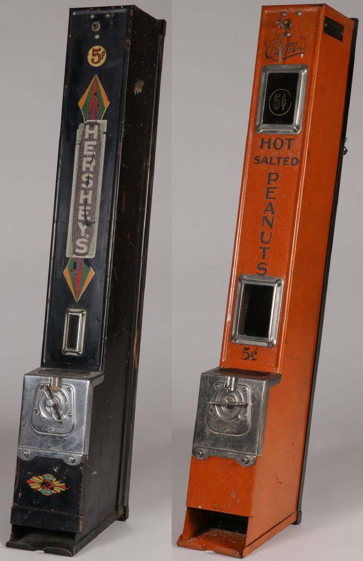 HERSHEY'S & CAM'S PEANUTS 5 CENT MACHINES: HERSHEY'S & CAM'S PEANUTS 5 CENT MACHINES. Comprising a black metal Hershey's five cent wall mounted vending machine probably by Advanced Machine Company, Chicago. Height 33.5 inches. Together with a