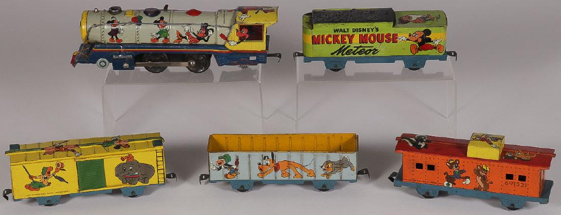 A MARX DISNEY TOY TRAIN SET: A MARX DISNEY TOY TRAIN SET. Comprising one engine and four cars all O gauge. Entitled "Walt Disney's Mickey Mouse Meteor". Greatest length 11 inches (28 cm).