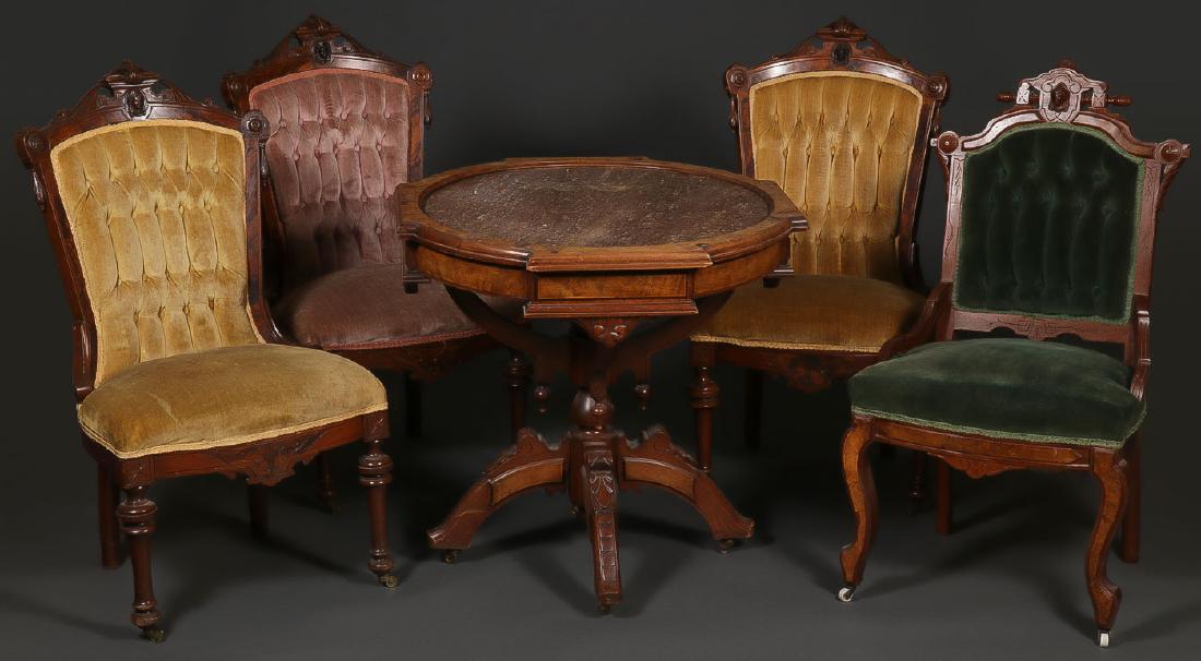RENAISSANCE REVIVAL TABLE AND CHAIRS: RENAISSANCE REVIVAL TABLE AND CHAIRS. Comprising three matching walnut chairs with turned front legs and the crest with carved liberty style heads and velvet upholstery, together with a similar but no