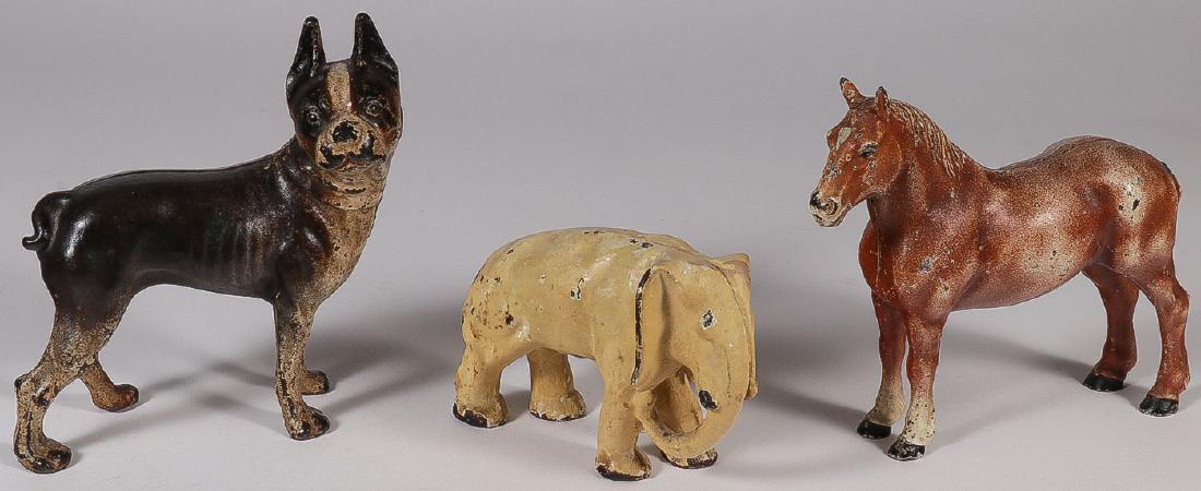 THREE CAST IRON FIGURAL DOOR STOPS, CIRCA 1900: A GROUP OF THREE CAST IRON FIGURAL DOOR STOPS, CIRCA 1900. Comprising a bulldog, an elephant and a horse. Greatest height 8.5 inches (21.5 cm).