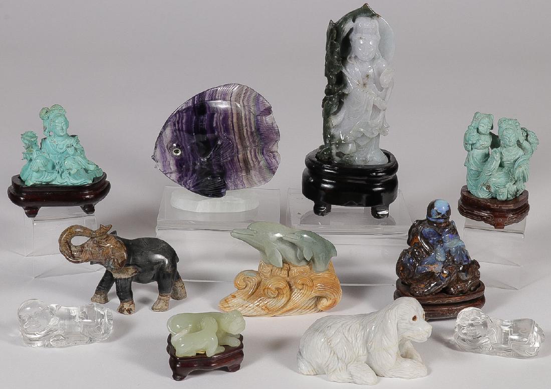 11 CHINESE HARDSTONE CARVINGS: 11 CHINESE HARDSTONE CARVINGS. Comprising two carved rock crystal reclining figures, a Kwan Yen with conforming wood base, Foo dogs, an elephant, turquoise figures, dolphins, exotic fish, and an exoti