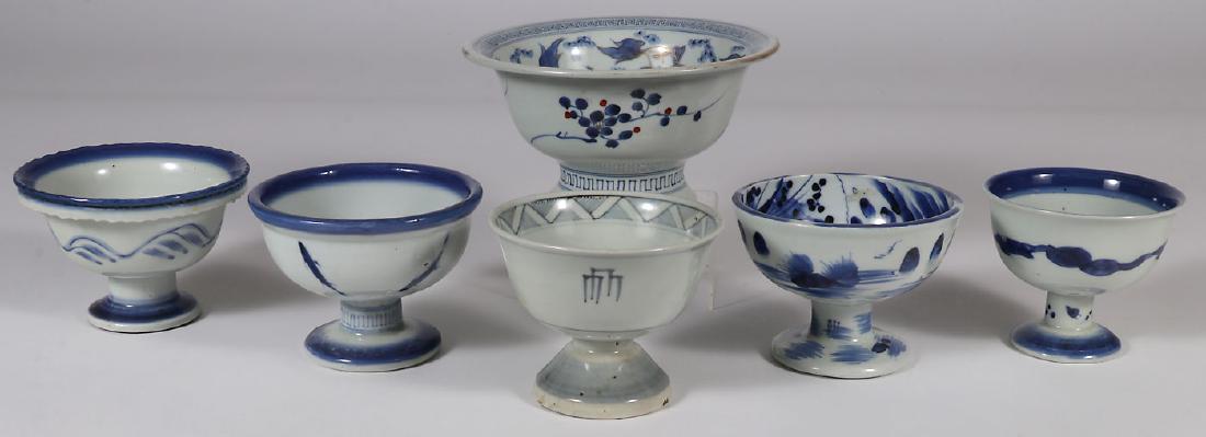 JAPANESE IMARI PORCELAIN FOOTED BOWLS, EDO-MEIJI: JAPANESE IMARI PORCELAIN FOOTED BOWLS, EDO - MEIJI PERIOD. Comprising one large specimen, the interior decorated with fish. Together with four blue and white smaller specimens, mostly with aquatic sce