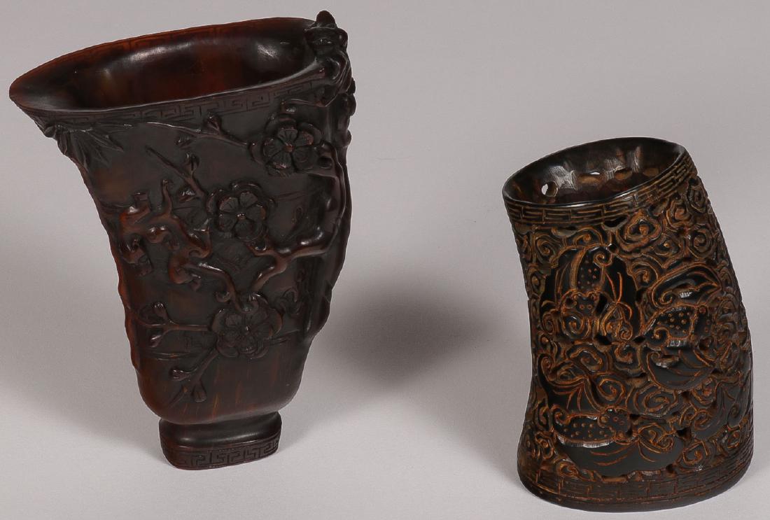 CHINESE CARVED HORN PIECES: CHINESE CARVED HORN PIECES. Comprising a carved buffalo horn libation cup, the sides carved in high relief of panthers crawling amidst trees, height 6 inches (15.2 cm). Together with a carved buffalo