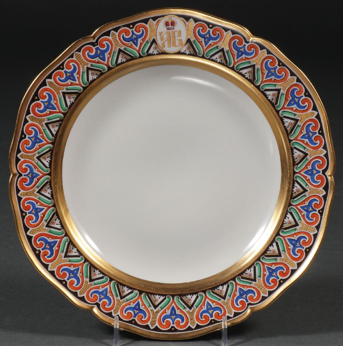 KPM PLATE RUSSIAN GD VLADIMIROVICH SERVICE: A KPM PORCELAIN PLATE FOR THE RUSSIAN GRAND DUKE ANDREI VLADIMIROVICH SERVICE, 19th C. The scalloped rim gilded and the border with multi-colored repeating pattern on black field and with Cyrillic