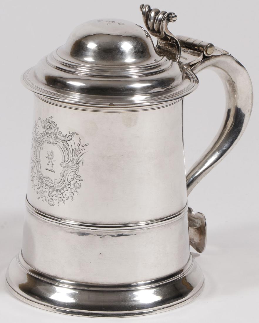 GEORGE II SILVER TANKARD, ROBERT BROWN, 1737: A FINE GEORGE II SILVER TANKARD, ROBERT BROWN, LONDON 1737. Resting on a slightly flared ring foot with banded tapering sides, stepped dome hinged lid, with ornate thumbpiece atop s-scroll handle