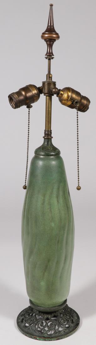 A RARE TECO LAMP BASE, FRITZ ALBERT: A RARE TECO LAMP BASE, FRITZ ALBERT. Green matte glaze with charcoal highlights and the sides with incised wavy pattern, mounted on a bronze pierced base with fitted collar and lamp hardware. Undersi