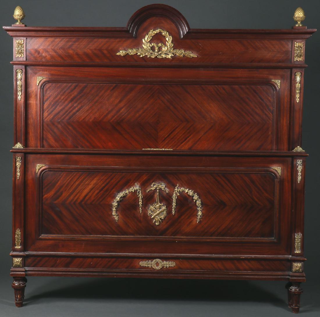 A FRENCH EMPIRE REVIVAL BED, 19TH CENTURY: A FRENCH EMPIRE REVIVAL BED, 19TH CENTURY. The headboard and footboard similarly decorated with ormolu mounts, the headboard with arched crest and gilt bronze finials. The headboard height 58 inches (
