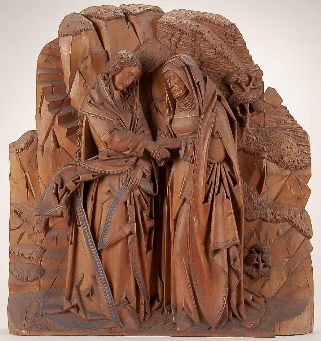 LARGE CARVED GOTHIC SHRINE: A LARGE AND IMPRESSIVE CARVED GOTHIC STYLE TRIPTYCH OF THE VISITATION, GERMAN 19TH CENTURY. The ornate base with carved openwork Gothic style arched elements supporting a larger central triptych openi